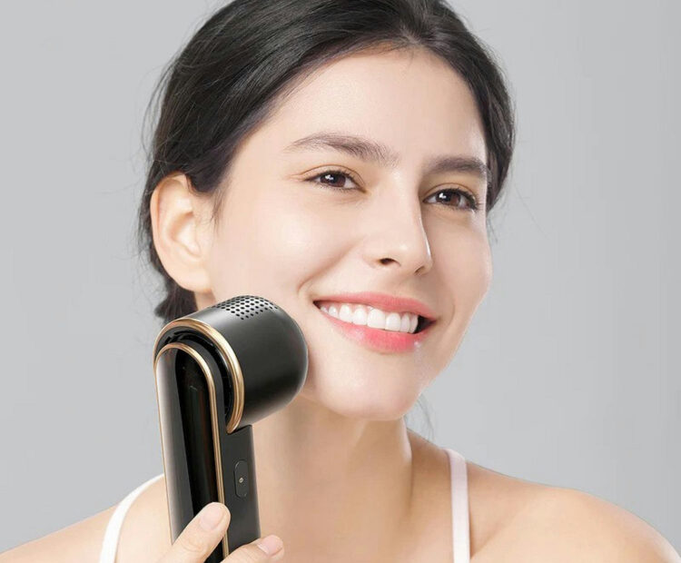 woman using skin care device